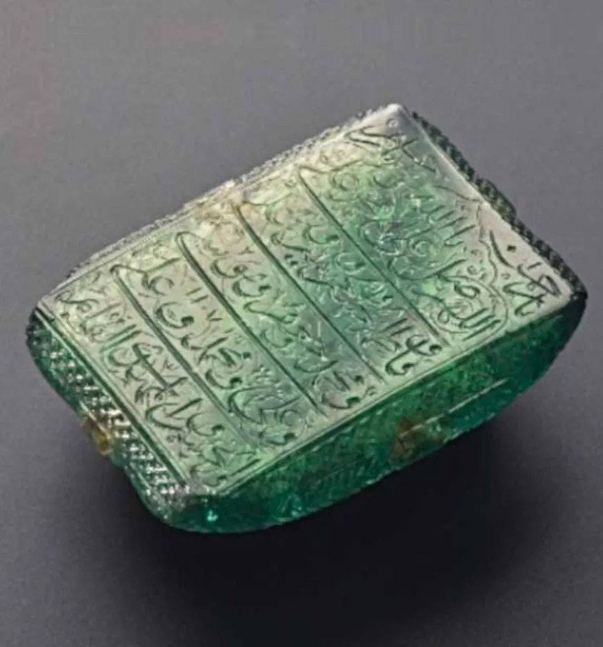 The Mogul Emerald, a large rectangular emerald inscribed with Arabic script.