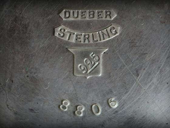 Close-up of sterling silver hallmarks stamped with "DUEBER STERLING," a 925 purity mark, and the number 8806 on a vintage silver surface.