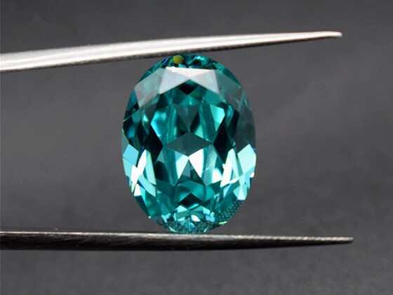 A radiant Paraíba Tourmaline gemstone with vivid electric blue-green color, exemplifying a top choice for gemstone investments.