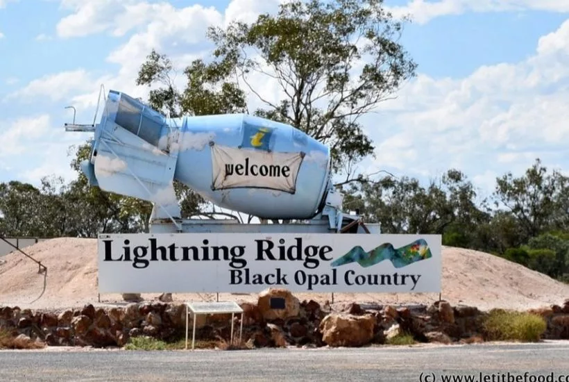 Welcome sign at Lightning Ridge featuring a painted cement mixer, marking the entrance to Australia’s iconic black opal mining town.