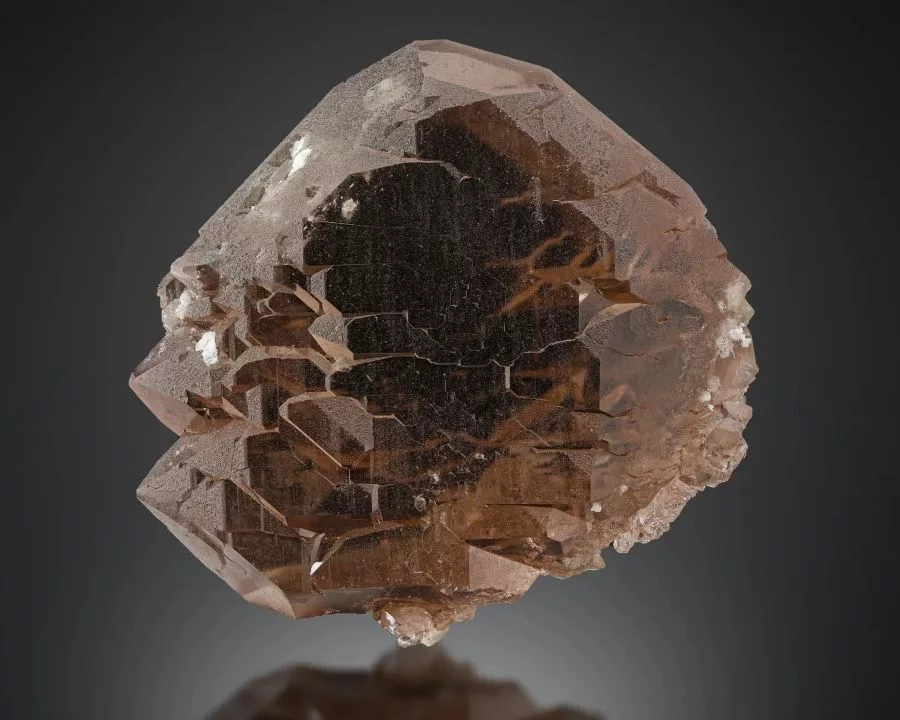 A striking specimen of gwindel quartz displaying its characteristic twisted, parallel crystal growth, with a smoky brown hue and sparkling surfaces, set against a dark gradient background.