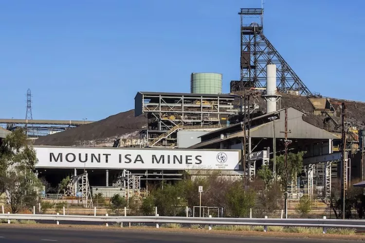 A wide-angle view of the Mount Isa Mines industrial complex in Queensland, Australia, featuring tall smokestacks, processing facilities, and sprawling infrastructure under a clear blue sky—an iconic site among Geological and Mineral Destinations in Australia.