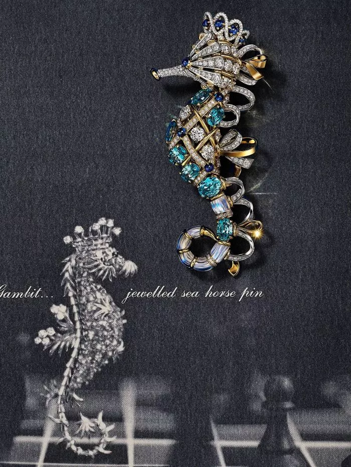 A jeweled sea horse pin adorned with sparkling blue and white gemstones and gold accents, displayed against a dark textured background with a vintage sketch of the sea horse pin and the text "Blue Book 2025: Sea of Wonder," representing Tiffany & Co. in 2025.